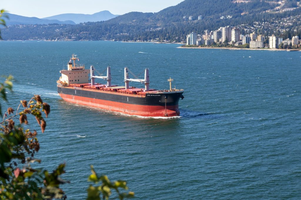 cargo ship sailing near city